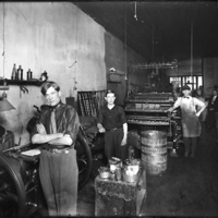 [Men posing at their workstations in a printing shop]