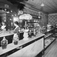 [Young woman at a soda fountain counter]