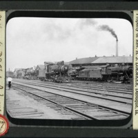 [Steam engines on the tracks in the Milwaukee Railroad yards]