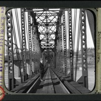 [On a railroad bridge crossing the Mississippi River]